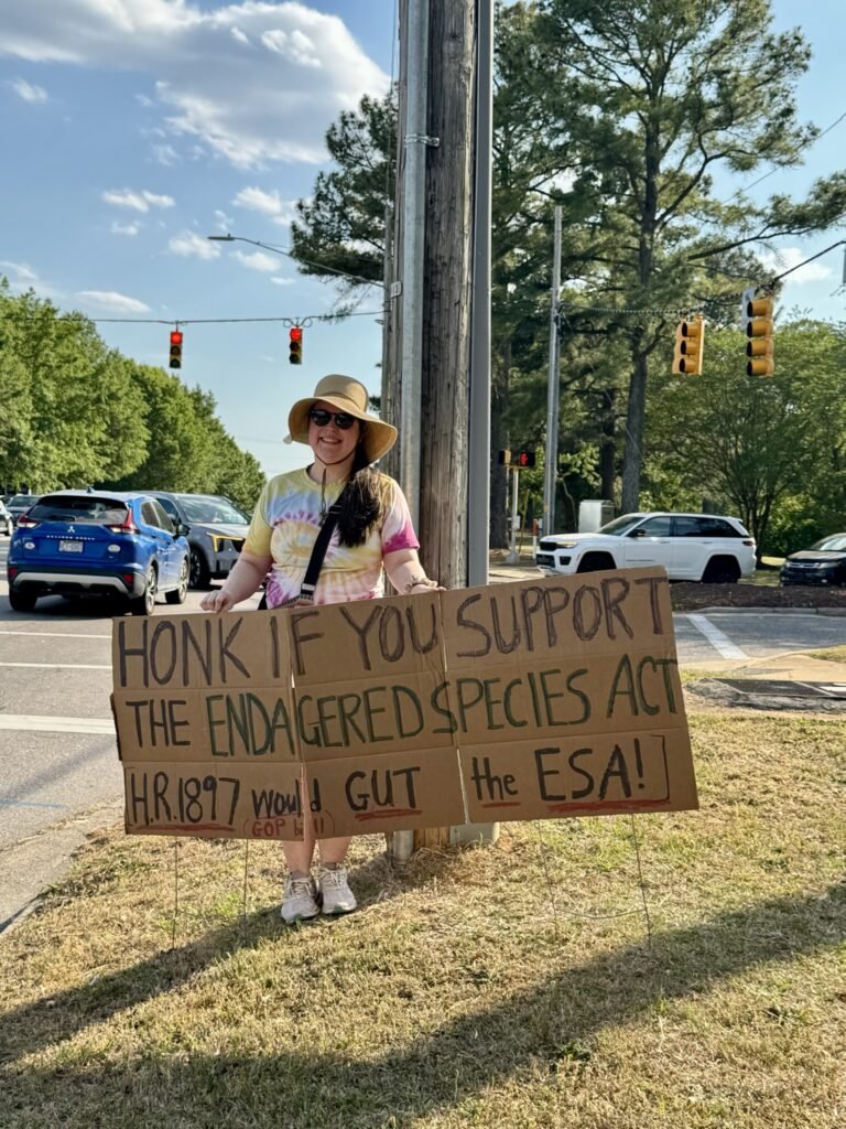 Wake Forest Earth Day protest - activist with Honk if you Support the Endangered Species Act sign