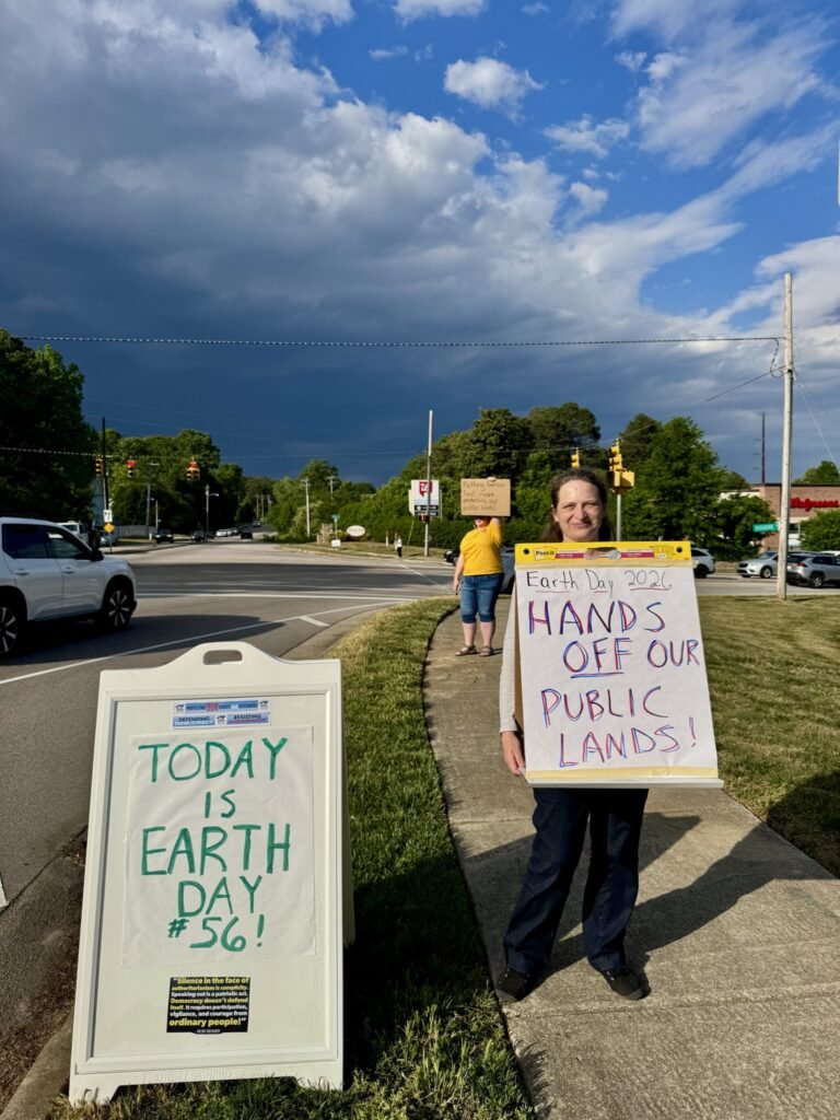 Wake Forest Earth Day protest - activist holding sign at Rogers Rd intersection
